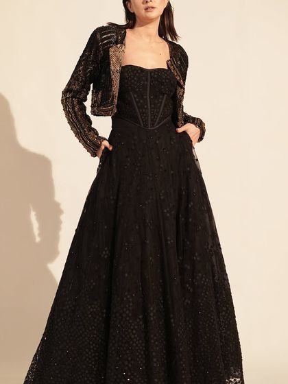 Black is always a classic. This stunning black gown with a heavily embellished jacket is the epitome of evening glamour. Perfect for a reception or black-tie event.