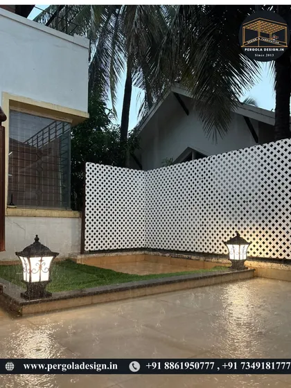 Even in the rain, the surrounding garden area remains a beautiful view from the dry comfort of the glass room. The exterior is just as important, with landscape lighting and a lattice privacy screen completing the scene.