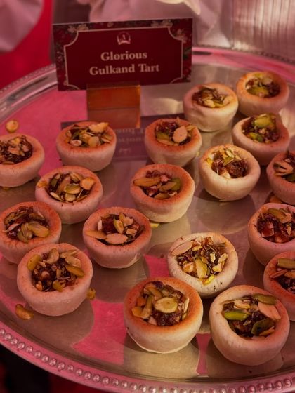 A fusion of flavours: our Glorious Gulkand Tarts. These bite-sized tarts have a buttery shell filled with a sweet and fragrant rose petal jam, topped with nuts.