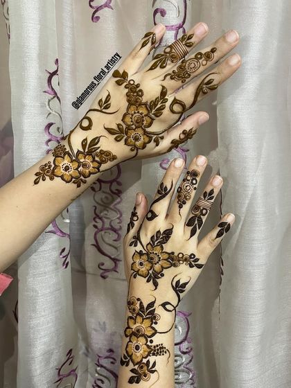 A delicate and modern design featuring floral vines that gracefully wrap around the hands and fingers, perfect for a minimalist look.