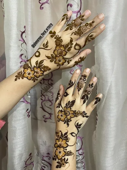 A delicate and modern design featuring floral vines that gracefully wrap around the hands and fingers, perfect for a minimalist look.