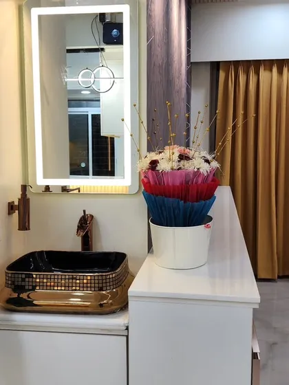 Another view of the dining area wash basin, showing the elegant gold-finished tap and the textured black and gold sink.