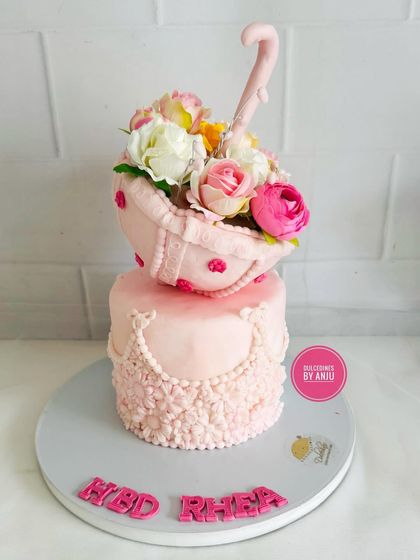 Another angle of the incredibly detailed umbrella cake, showcasing the handcrafted flowers.