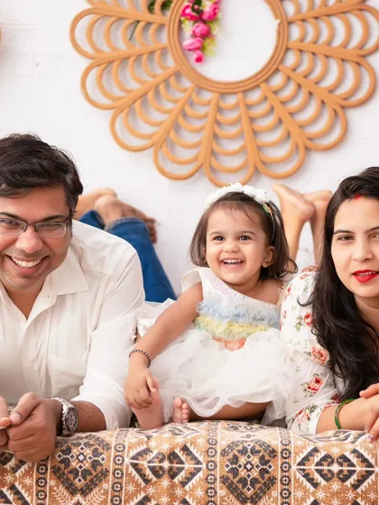 A relaxed and happy family moment. Lying on the bed in our boho setup, this family shares a genuine laugh, a perfect candid memory.