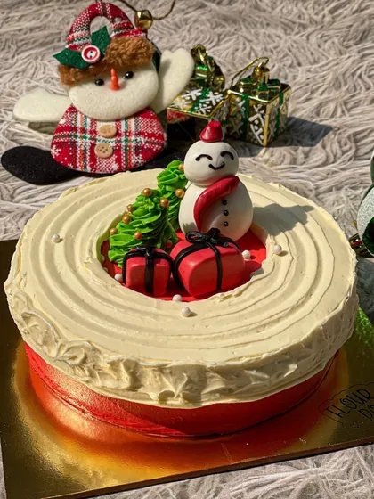 My buttercream chocolate Christmas cake is a showstopper. It's decorated with a cute edible snowman and presents, all made from chocolate.
