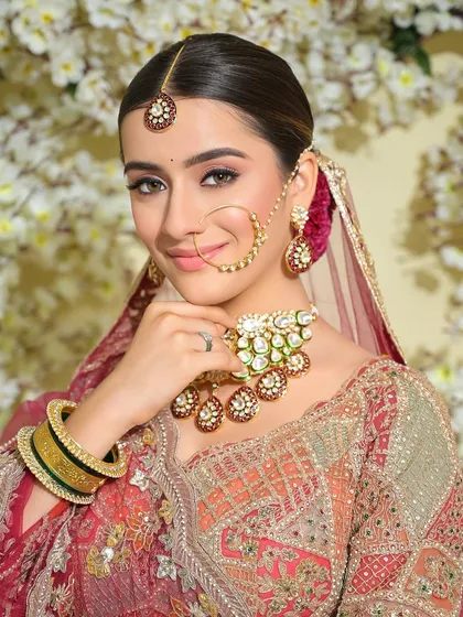 A classic bridal portrait. The makeup is kept minimal and radiant, with a focus on flawless skin and a touch of color on the lips.