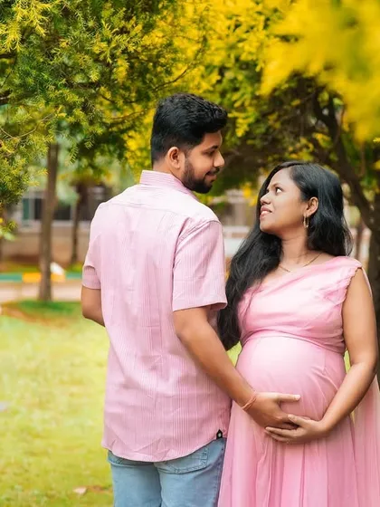 A candid, walking shot of an expecting couple in a park. Capturing these unposed moments of interaction results in authentic and heartfelt images.