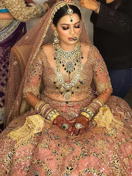 My NG bride, looking serene and beautiful while getting ready. The pastel lehenga with green jewellery is a gorgeous combination.