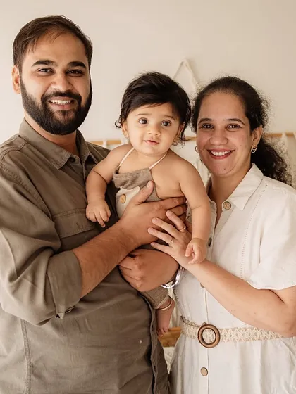 A classic family portrait with a six-month-old baby. Everyone is looking at the camera, creating a lovely memory of this milestone.