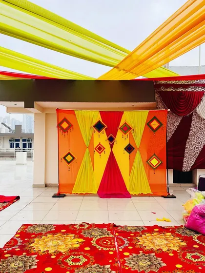 The simple and colorful backdrop stands ready for the Haldi ceremony to begin. My work is about creating the perfect setting for your memories.
