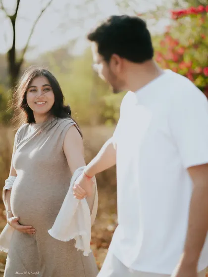 A candid, happy moment between an expecting couple. Her joyful expression as she looks at her partner tells a story of love and shared dreams.