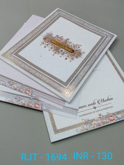 A classic invitation with a floral border and a simple, elegant layout. The design is timeless and suitable for a formal wedding.