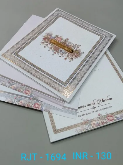 A classic invitation with a floral border and a simple, elegant layout. The design is timeless and suitable for a formal wedding.