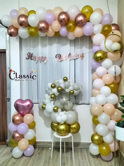 This home birthday decoration features a pastel balloon arch combined with a number '1' balloon bouquet. It's a great example of how we can mix and match different decorative elements to fit your space.