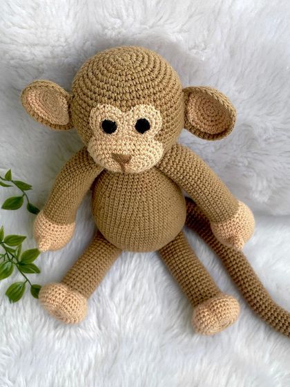 A playful monkey with a long tail, perfect for swinging around. This is my own custom design, and he's ready for lots of jungle adventures.