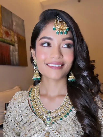 Getting my beautiful Muslim bride ready for her Walima. I created a soft, glowing look with a touch of pink on the eyes to complement her stunning ivory and green outfit.