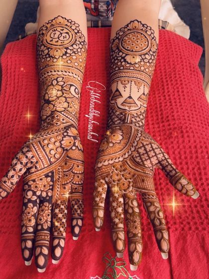 A lovely engagement design with jhumka motifs and the couple's initials elegantly placed in the center of a floral mandala.