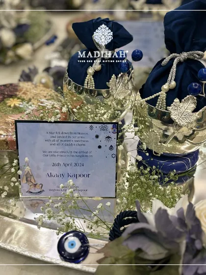 This unique baby announcement hamper is designed around the protective Evil Eye theme. It features a personalized announcement card, silver-plated bowls with navy blue pouches, and the traditional nazar symbol to bestow blessings and ward off negativity.