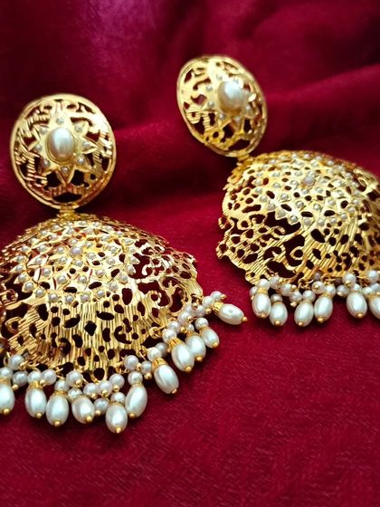 The 'सेवंती' (Sevanti) big Jadau earrings. These feature intricate filigree work and pearl drops, making them a grand and beautiful choice for any celebration.