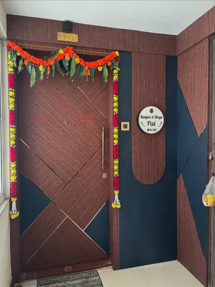 The main door decorated for a housewarming ceremony, showing how the design serves as a beautiful backdrop for festive occasions.