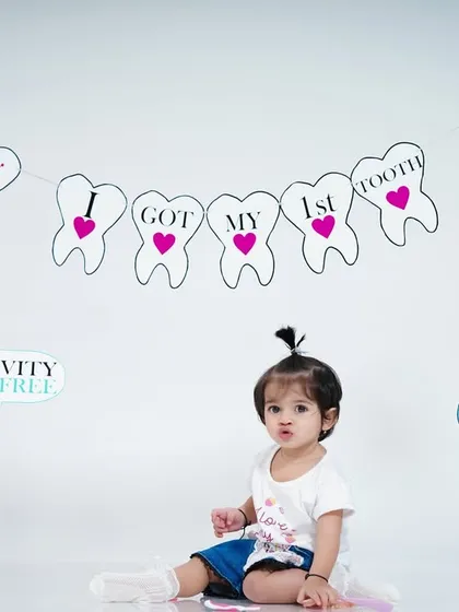 "I got my first tooth!" We celebrate even the smallest milestones with fun and creative shoots like this one, complete with a custom banner and props.