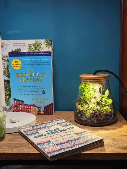 A terrarium lamp on a bedside table, creating a cozy and calming atmosphere. It's a functional piece of decor that brings nature right to your personal space.