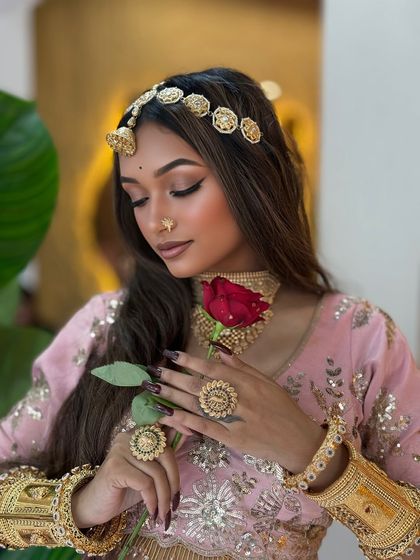 A romantic shot with a rose. The makeup is kept fresh and dewy, perfect for a daytime event.