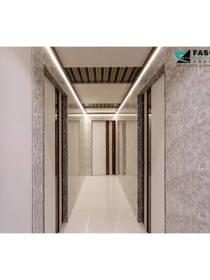 This image showcases a long passageway in a Bhiwandi residence. We used continuous linear lighting on the ceiling and textured wall panels to create a visually interesting and well-lit path through the home.