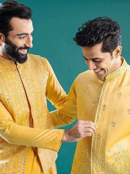 A moment of camaraderie between friends, all dressed in our vibrant yellow kurta and jacket sets. This image captures the joy of celebrating together in perfectly coordinated style.