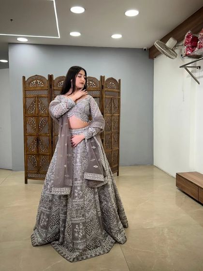 A stylish pose in the grey embroidered lehenga, showing off its unique design and flattering silhouette. A great pre-loved find for a fashion-forward look.
