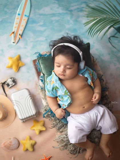 Such a dashing little dude already. He's relaxing with his headphones on in this fun, beach-themed newborn session.