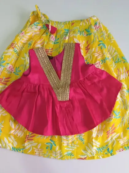 A closer look at the vibrant Meera Set. The hot pink cotton silk choli features a non-pokey lace detail, and the yellow floral ghagra is fully lined with soft cotton, making it a bright and comfortable choice for any party.
