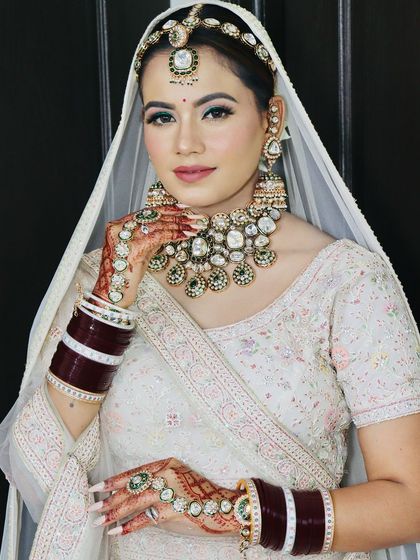 A close-up of the bride, her makeup perfectly complementing her outfit.