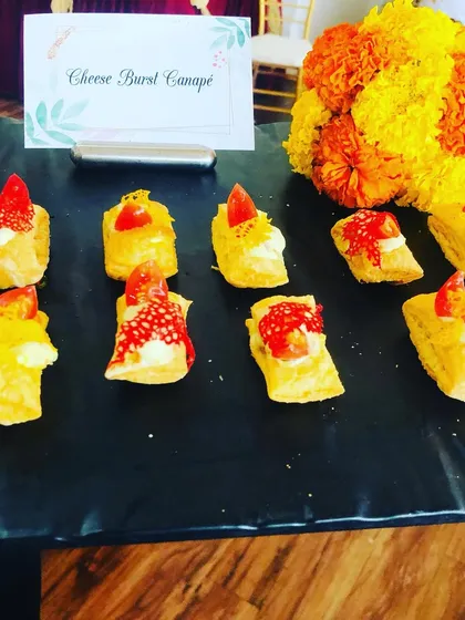 These Cheese Burst Canapés are a savory delight. Flaky puff pastry is filled with creamy cheese and topped with a sweet and spicy garnish, creating a perfect balance of flavors.