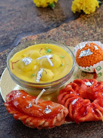 My 'Mooh Meetha' candle box, featuring a variety of my most realistic dessert candles. This set includes a rasmalai bowl, a gujiya, an imarti, and a laddoo candle.