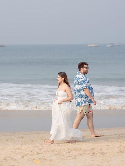 A beautiful composition of the couple walking apart but connected, with the vast ocean as a backdrop, telling a story of their journey together.