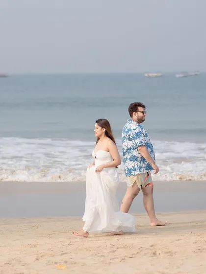 A beautiful composition of the couple walking apart but connected, with the vast ocean as a backdrop, telling a story of their journey together.