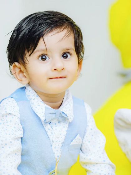 A bright and cheerful portrait of Kiyansh at his first birthday celebration. I use the colorful party decor as a vibrant background for memorable baby portraits.