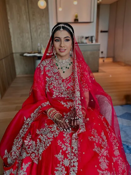 A seated portrait of the bride, looking every bit the part of a modern-day queen. The makeup is regal, and the outfit is breathtaking.