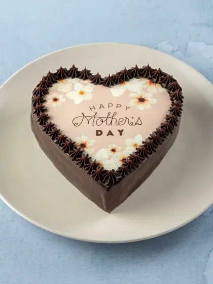 This heart-shaped chocolate cake with a floral 'Happy Mother's Day' print is a simple and sweet way to show your love. It's a classic Belgian chocolate cake that every mom will enjoy.