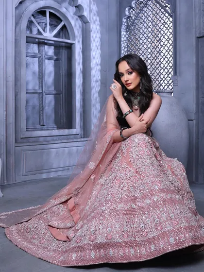A stunning full-length shot that captures the grandeur of the lehenga. The model looks like a modern-day princess.