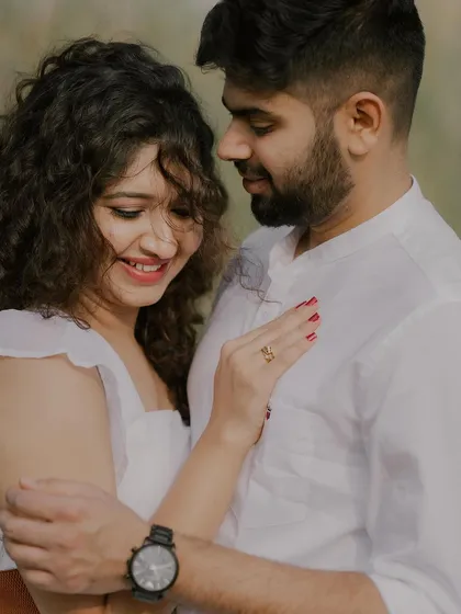 A close-up shot capturing a gentle, happy moment. The soft focus on the background emphasizes the couple's connection and the bride's joyful expression.
