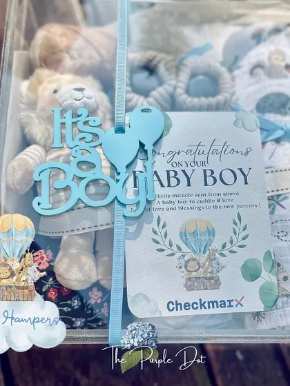 A sweet "It's a Boy!" hamper to welcome a new arrival. This gift, presented in a clear acrylic box, includes a soft lion toy, baby booties, and a personalized congratulatory card.