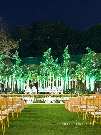 An enchanted forest comes to life on this outdoor stage. I used illuminated trees and hanging floral strings to create a magical, woodland atmosphere for an evening reception under the stars.