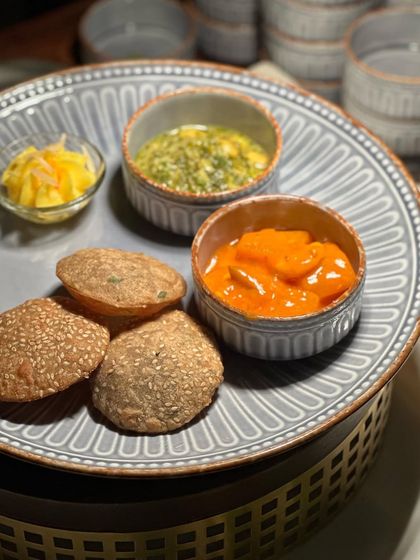 Another view of our traditional Indian plate, highlighting the rustic yet elegant ceramicware we use to enhance the dining experience.