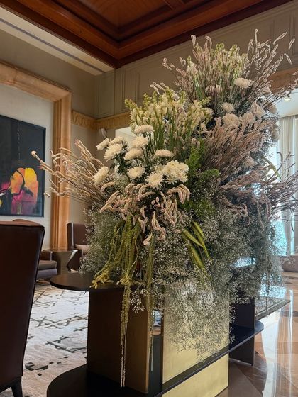 An all-white arrangement brings a sense of serene elegance to the lobby. Here, I've used a variety of white flowers and dried elements to create a piece that is rich in texture and subtlety.