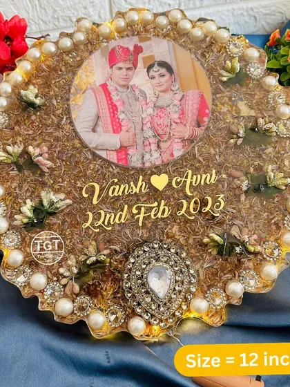 A 12-inch zig-zag resin frame with built-in LED lights. This piece preserves wedding flowers and includes a central photo and a large decorative brooch.