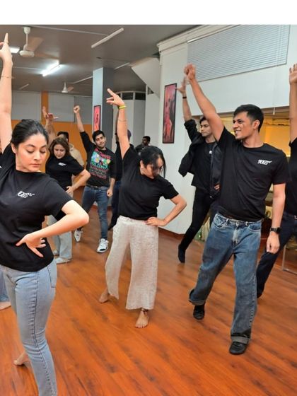 The energy is high as our class strikes a pose together. Our studio is a place of expression and shared passion.