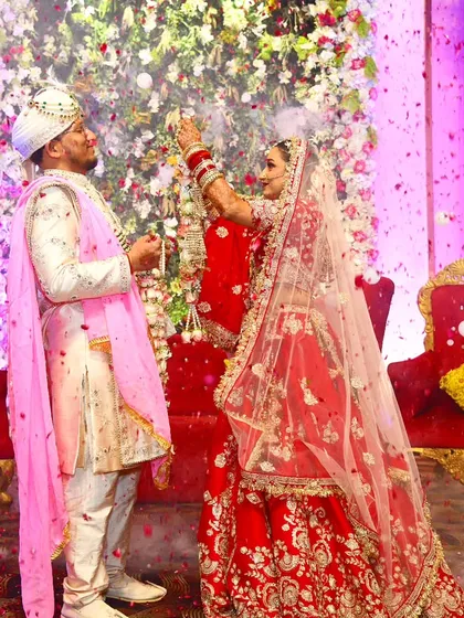 The Jaimala or Varmala ceremony is a beautiful tradition. I captured this moment with a shower of flower petals, freezing the couple's happy expressions and the festive atmosphere of the wedding.