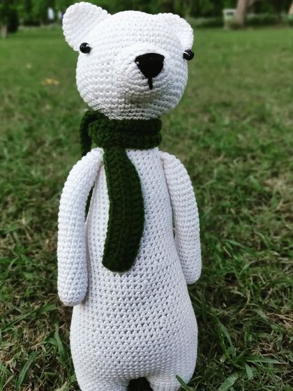 This is Brian, the adventurous and emotional polar bear who is all about spreading love and positivity. His green scarf adds a pop of color to his classic white coat.